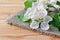 White apple flowers on a rag napkin on a wooden table