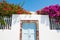 White architecture, blue door and pink flowers