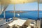 White architecture on Santorini island, Greece. Beautiful terrace with sea view of Caldera and cruise ship.