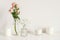 White arrangement of roses, baby`s breath flowers and candles. Copy space for lettering