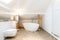 White attic bathroom with bathtub