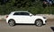 White Audi Q2 on the road side of a suburban residential district. Side view.