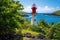 white automated lighthouse on a lush island