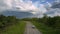 White automobile moves slowly along ruined road with pits