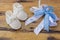 White Baby Boots with Blue Ribbon Bow on Rustic Wooden Surface, Gender Reveal Concept