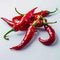 White background adorned with a close up of fiery red peppers