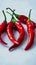 White background adorned with a close up of fiery red peppers