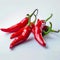 White background adorned with a close up of fiery red peppers