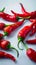 White background adorned with a close up of fiery red peppers