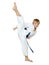 On a white background boy athlete in a kimono performs a kick leg circular insulated