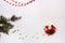 White background candle, fir branch, red beads, gold stars, new year, Christmas