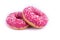 on a white background close-up shows sweet donuts with pink icing and white powder