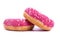 on a white background, closeup are donuts, covered with pink glaze, decorated with white powder