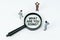 On a white background, figures of businessmen and a magnifying glass with the inscription - WHAT ARE YOU DOING