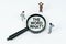 On a white background, figures of businessmen and a magnifying glass with the inscription - THE WORD WHAT