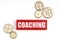 On a white background, gears and jenga with the inscription - COACHING