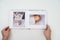 on white background, hands flip through photobook from home family photo shoot