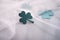 on a white background lies clover made of paper, a small decorative leaf