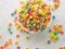 On a white background, multi-colored fruit cereal rings. High angle view. Quick whole grain breakfasts, sweet food. Children`s,