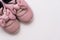 On a white background pink baby female sneakers, copy space