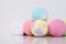 On a white background, a set of balls of multicolored sea salt with a towel, for taking a bath