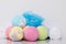 On a white background, a set of balls of multicolored sea salt with a towel and a washcloth