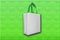 White Bag with green handle on Green texture Background