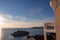 White balcony in luxury hotel in Budva Riviera with scenic view on idyllic Sveti Stefan island at sunset, Montenegro