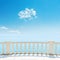 White balcony near sea and blue sky with clouds