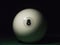 White ball number 8 from russian billiard pyramid in the dark