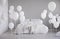 White balloons in grey minimal bedroom interior. Real photo