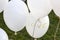 White balloons over grass saying `Love` at a wedding reception