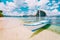 White banca island hopping boat at Las cabanas beach with amazing Pinagbuyutan island in background. Beautiful landscape