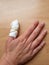 White bandage on imjured thumb on wooden background