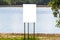 A white banner stands on the lake shore with a mockup