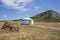 White Bashkir yurt stands between a haystack and a mountain