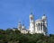 white basilica called notre dame de fourviere with bell towers L
