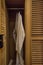 White bath robe hangs in closet