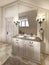 White bath sink with large mirror and sconces on the sides of th
