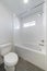 White bathroom interior with windows and gray tiles flooring