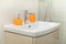 White bathroom sink white orange soap container - brown furniture and white faience. Clean picture