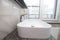 White bathroom with a window . Modern apartment. Spacious bathroom. White shell. The window in the bathroom. The design of the