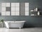 White bathtub, dark grey tiles, and three posters above.