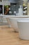 White bathtubs in a hardware store. The concept of choosing and installing bathtubs. vertical photo