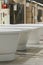 White bathtubs in a hardware store. The concept of choosing and installing bathtubs. vertical photo