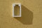 White battery icon on yellow textured wall