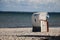 White beach chair is standing in the sand at the beach