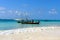 White beach and deep blue sea with fisherboats at the West coast of Sansibar