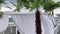 A white beach tent sways in the wind. View from the beach tent to the sea in Italy. Beach chair on the beach.