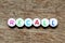 White bead with letter in word recall on wood  background